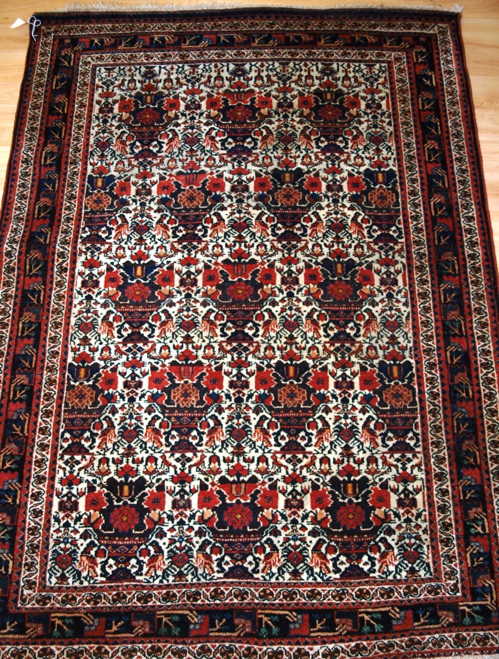 antique abedeh rug ivory ground with vase peacock design circa 190020