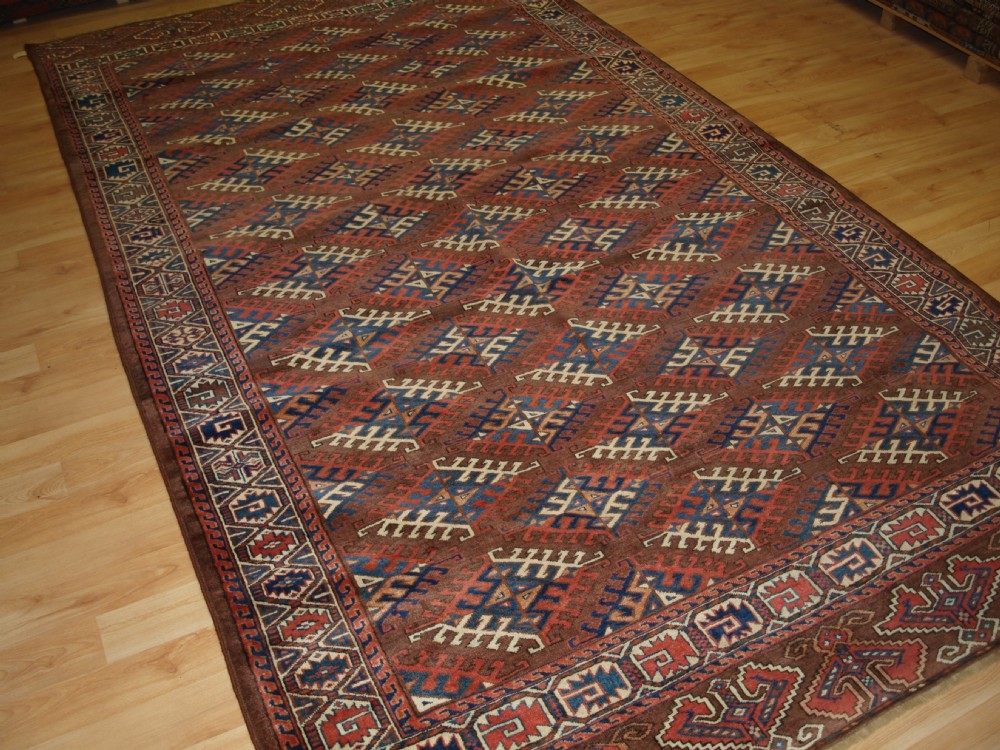 antique yomut turkmen main carpet with dyrnak gul design curl leaf border late 19th century