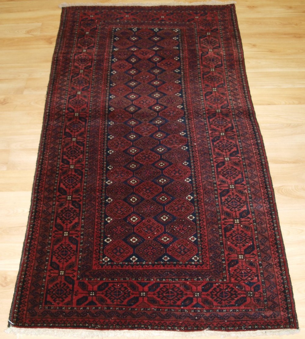 old baluch rug with repeat lattice design small size and fine weave circa 1920
