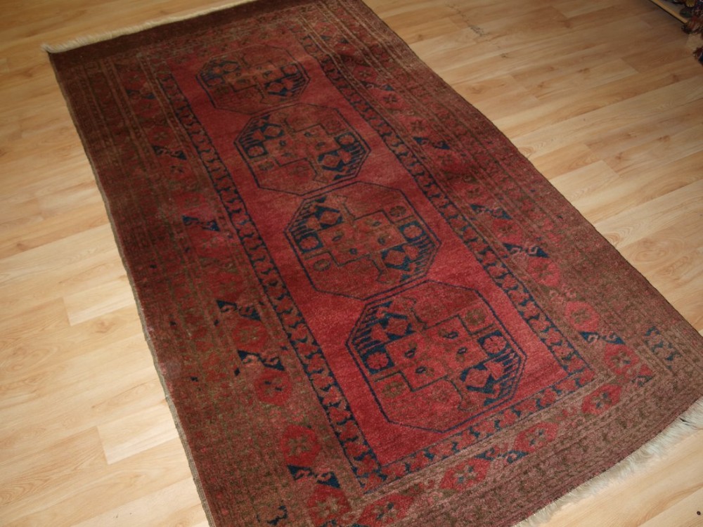 old afghan village rug of traditional design soft rose red colour circa 1920