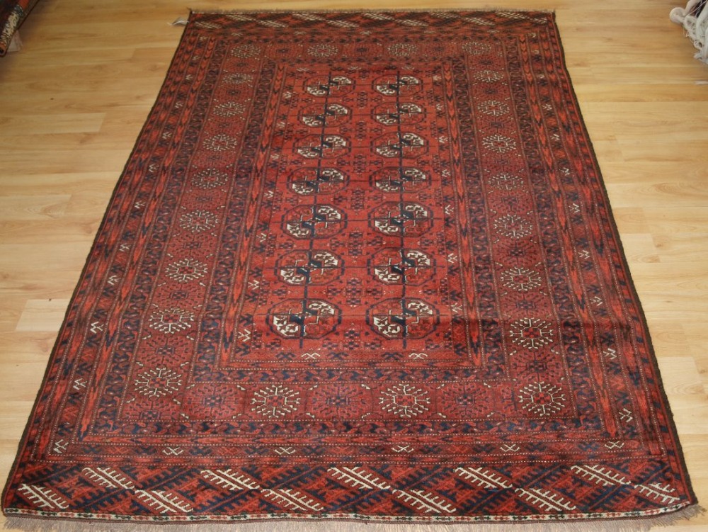 old afghan rug of traditional turkmen design soft red colour circa 1920