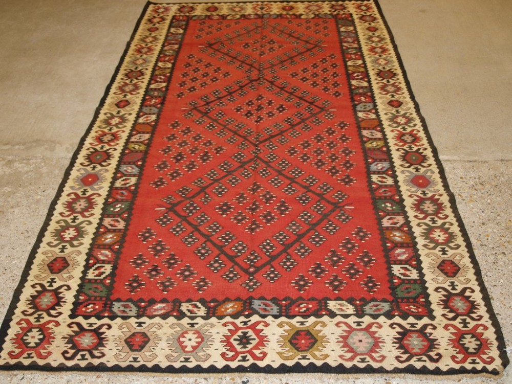 old turkish sarkoy kilim rug traditional design on soft red ground good ivory border circa 1920