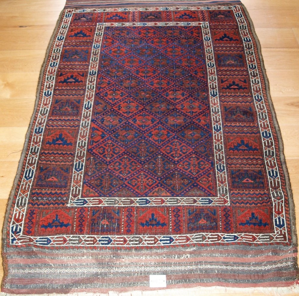 very rare antique baluch rug with calyx lattice field and yomut turkmen borders 2nd half 19th century