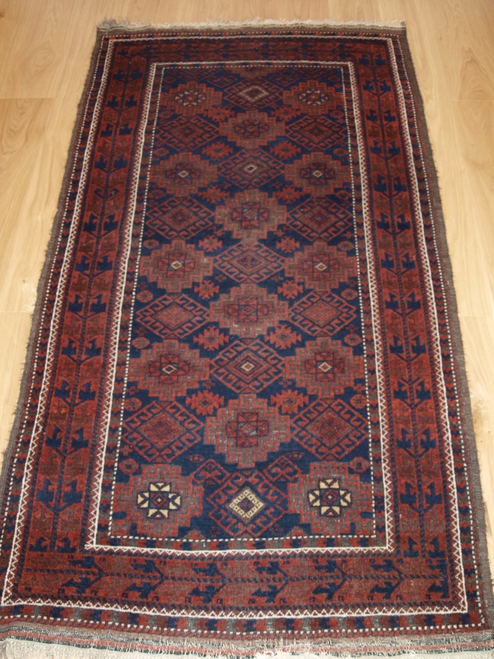 antique baluch rug with repeat design heavy corrosion circa 1900