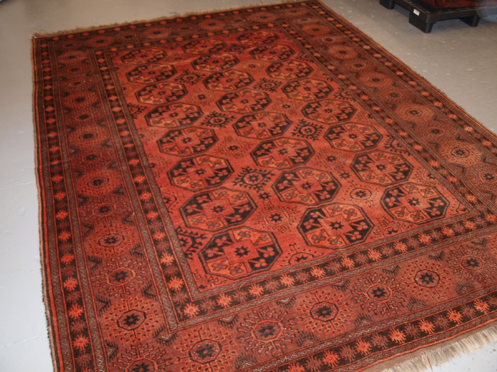 old afghan village carpet of traditional design soft burnt orange colour circa 1920