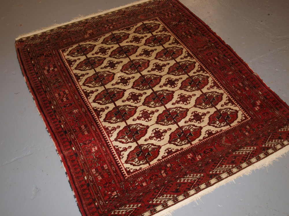 old afghan turkmen rug with tekke design on a scarce ivory ground circa 1920