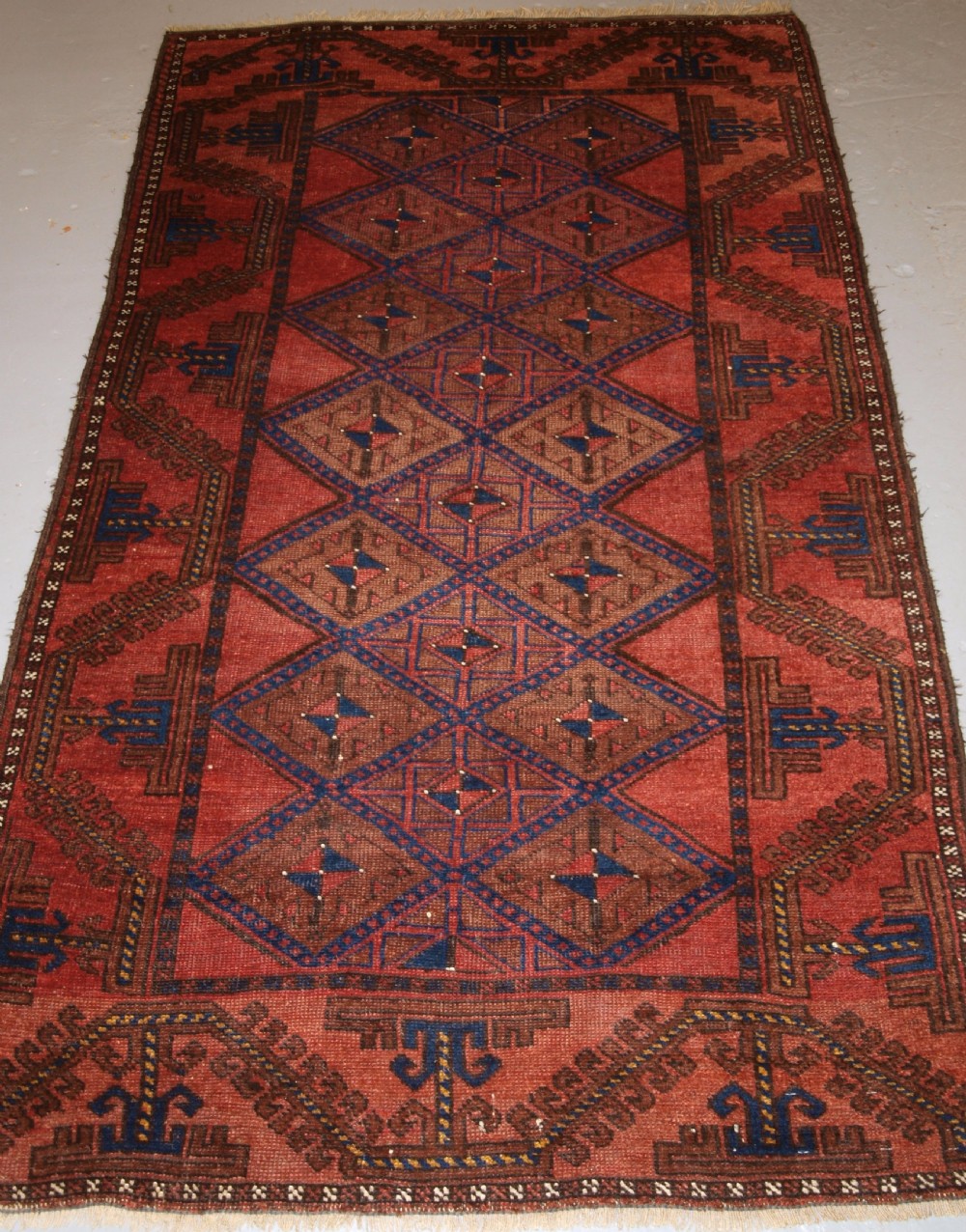 antique afghan rug of baluch lattice design warm colours circa 190020