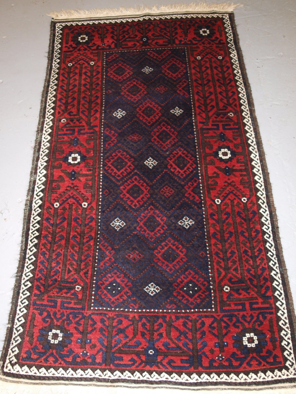 old afghan baluch rug with repeat design and classic baluch border circa 1920