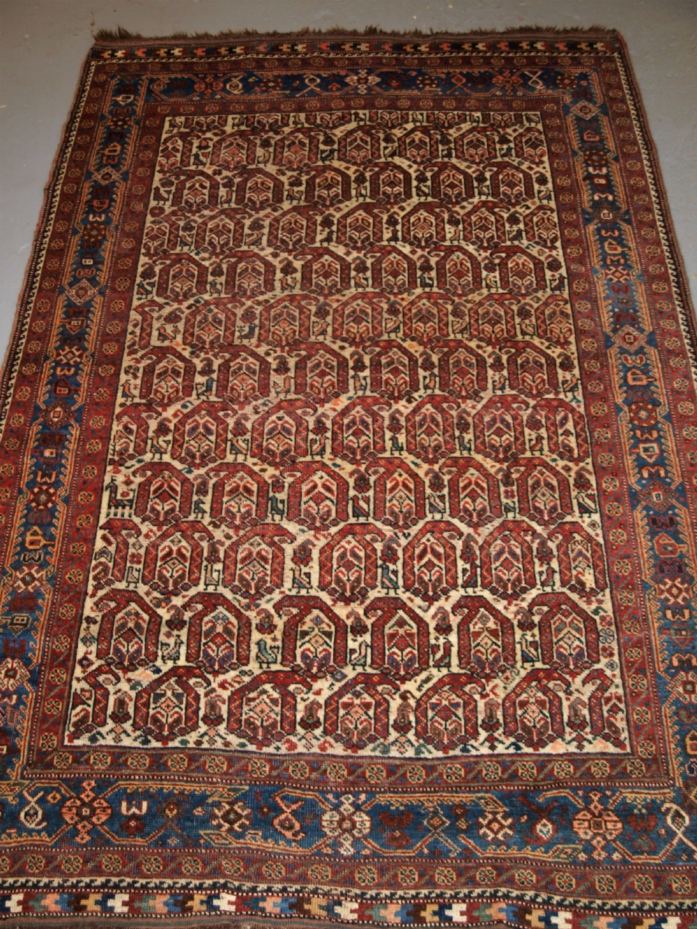 antique rug by the khamseh tribe all over boteh design on an ivory field circa 1900