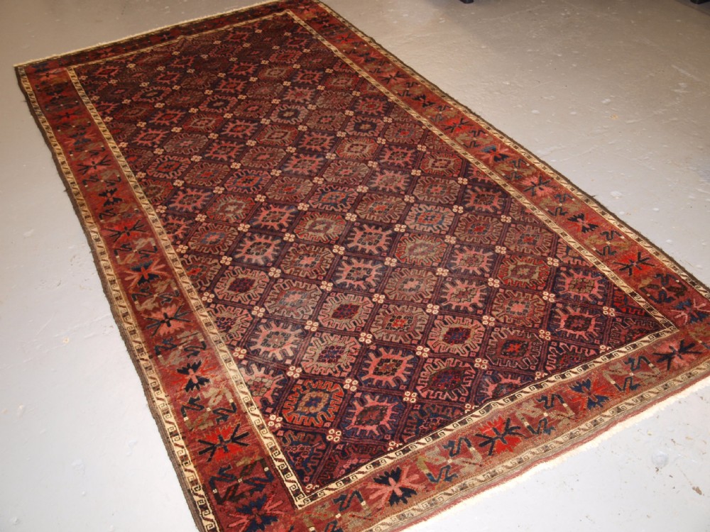 antique baluch rug with snow flake lattice design western afghanistan late 19th century