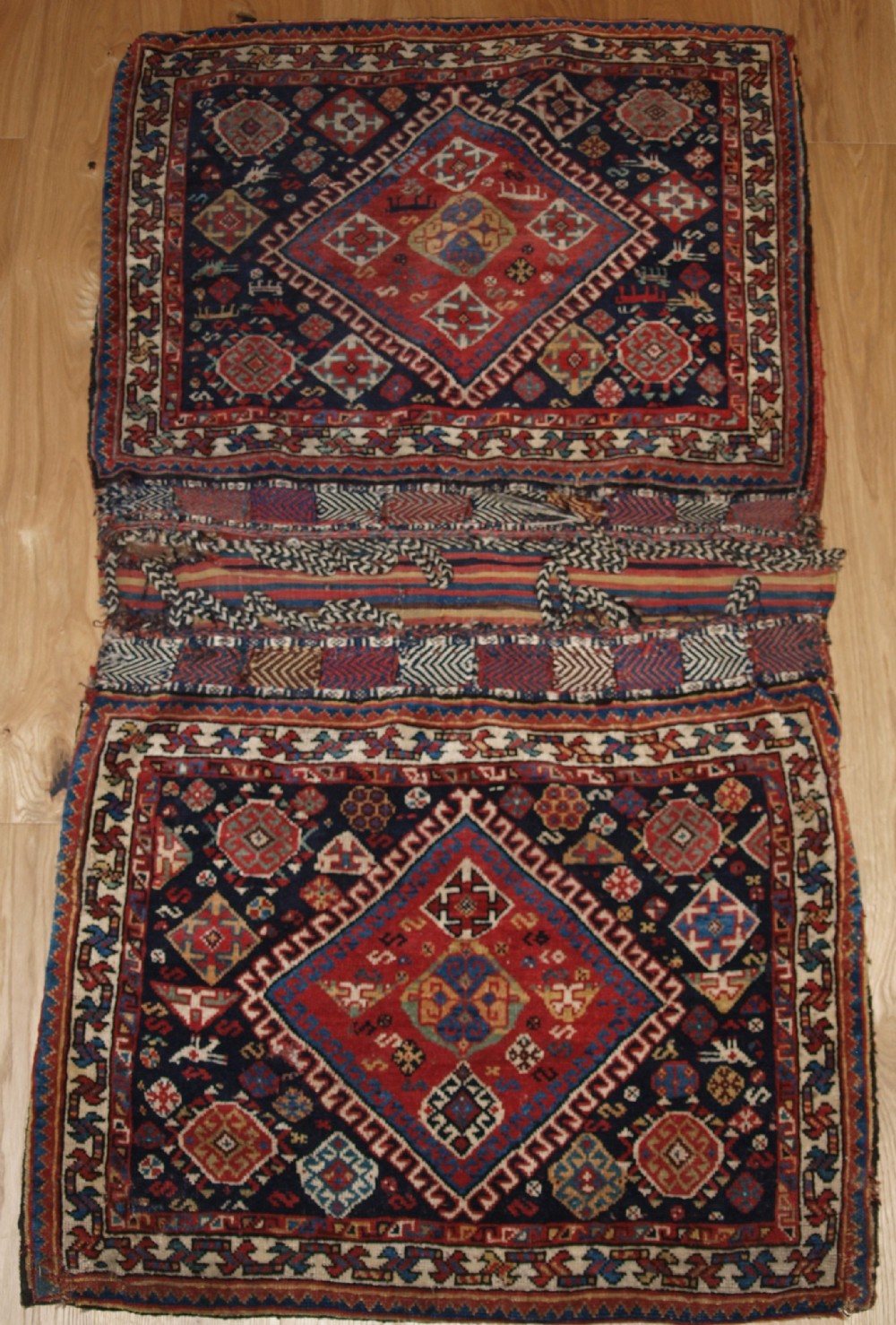 antique complete qashqai khorjin saddle bags of large size with plain weave back circa 1900