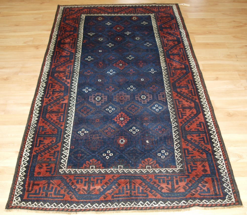 antique baluch rug with lattice design in superb blues boat border late 19th century