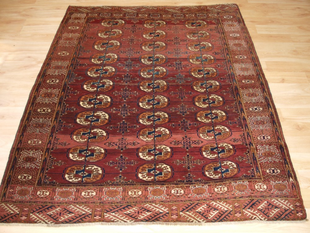 antique tekke turkmen rug with abrashed madder red field circa 1900