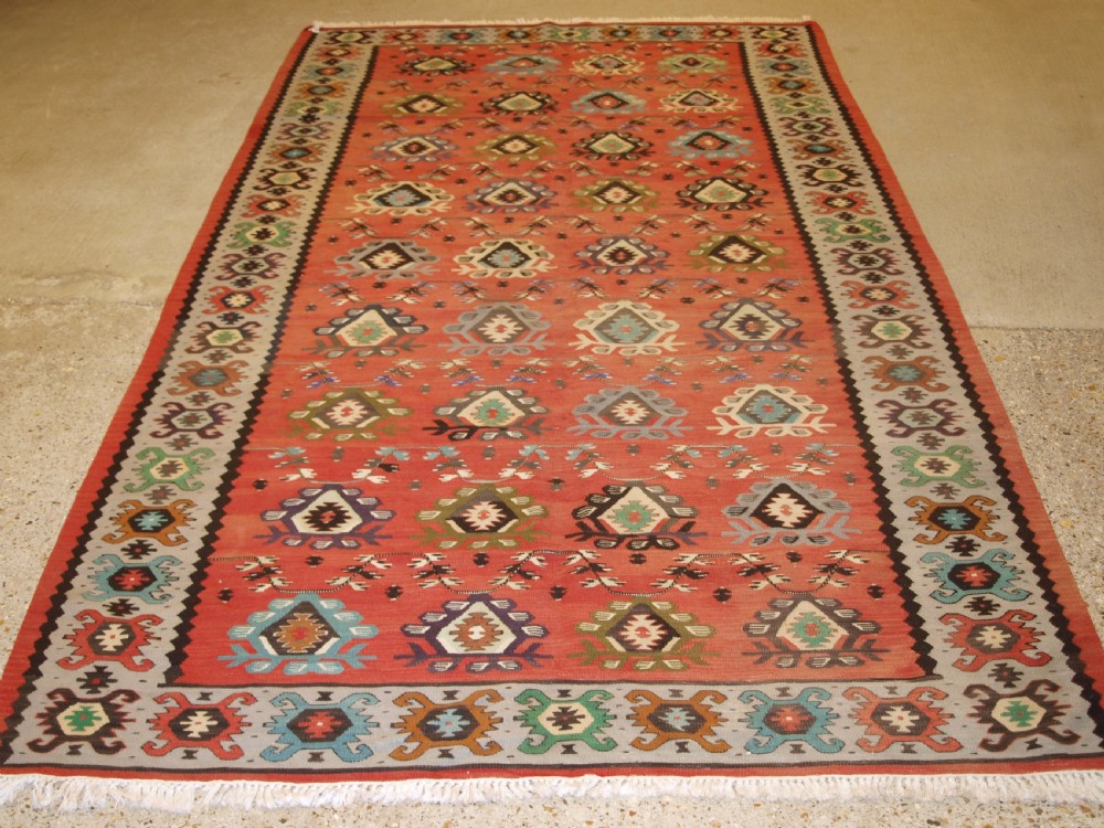 old sharkoy kilim with traditional all over design in soft colours circa 1920