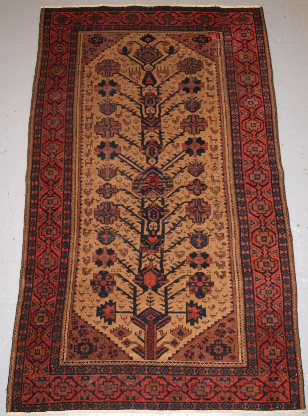 antique baluch ferdows region rug camel ground tree design late 19th century