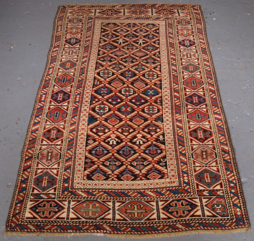 antique caucasian dagestan rug lattice design with human figures circa 1880