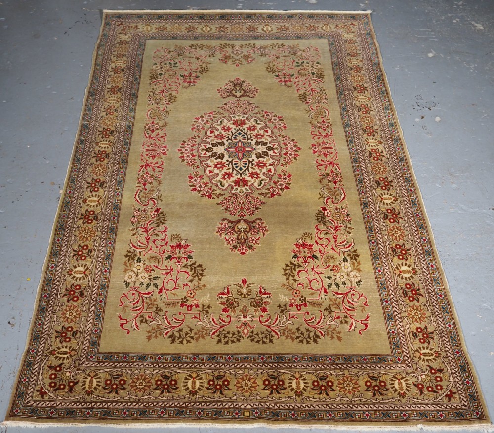 antique turkish hereke wool rug with scarce green ground circa 190020