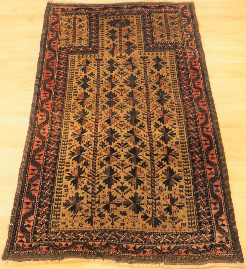 antique baluch prayer rug with tree of life design on a camel ground circa 1900