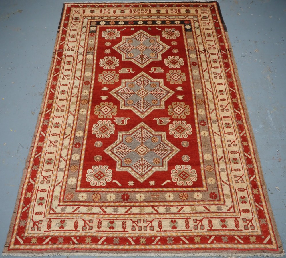 antique east turkestan khotan rug with three star medallions circa 1920