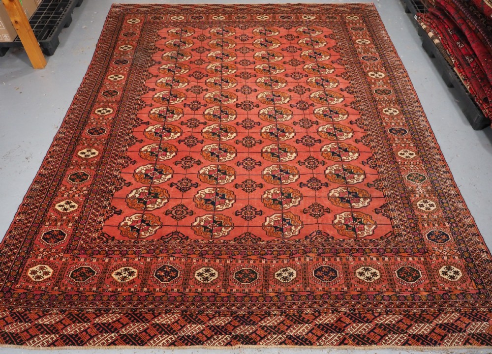 antique tekke turkmen main carpet in a soft warm pink red colour circa 1900