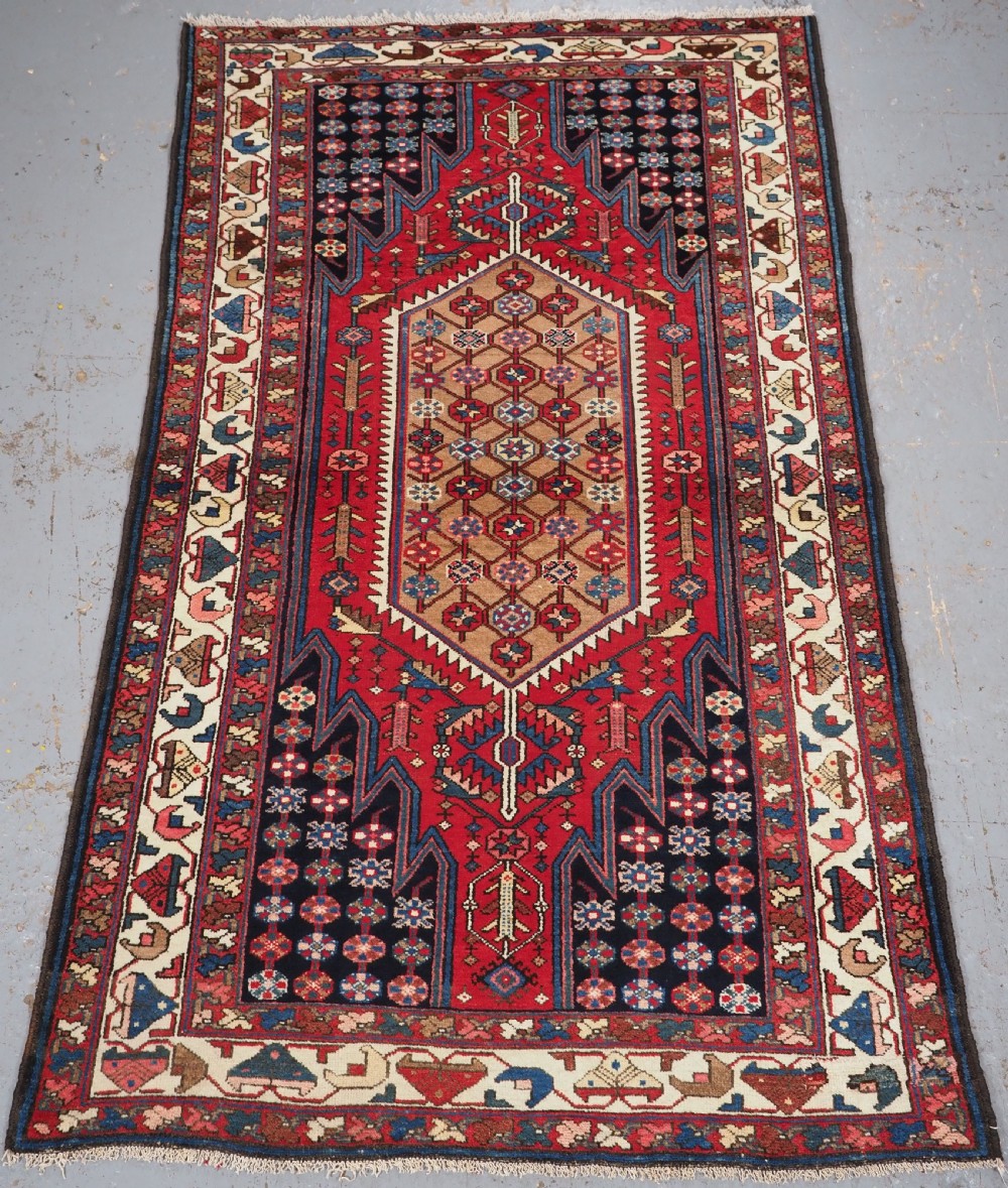 antique mazlahan rug of traditional design with camel ground medallion circa 190020
