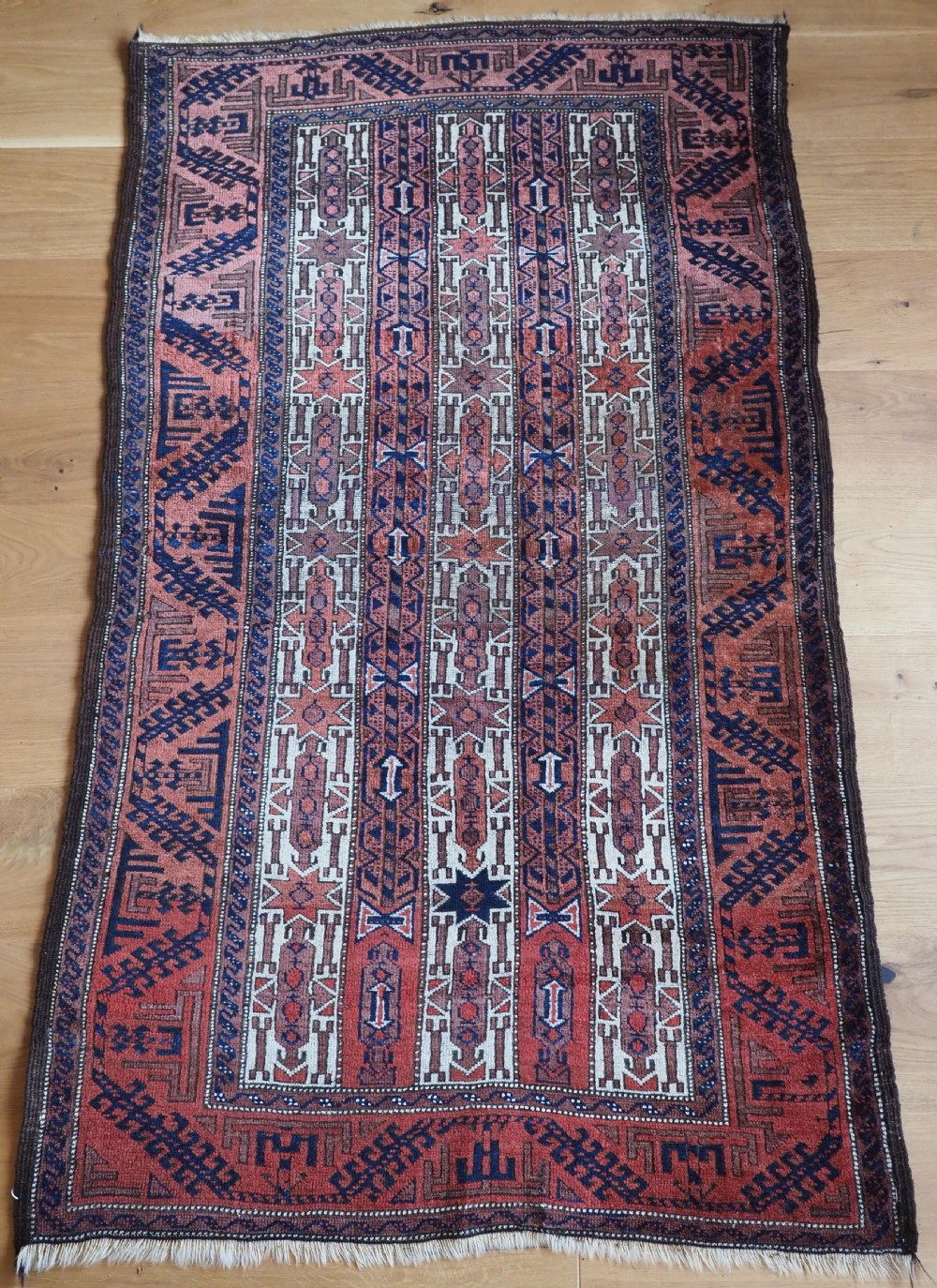 antique baluch rug with scarce white ground stripe design circa 1900