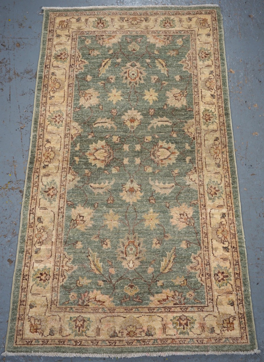 hand knotted afghan ziegler design rug with green ground about 10 years old