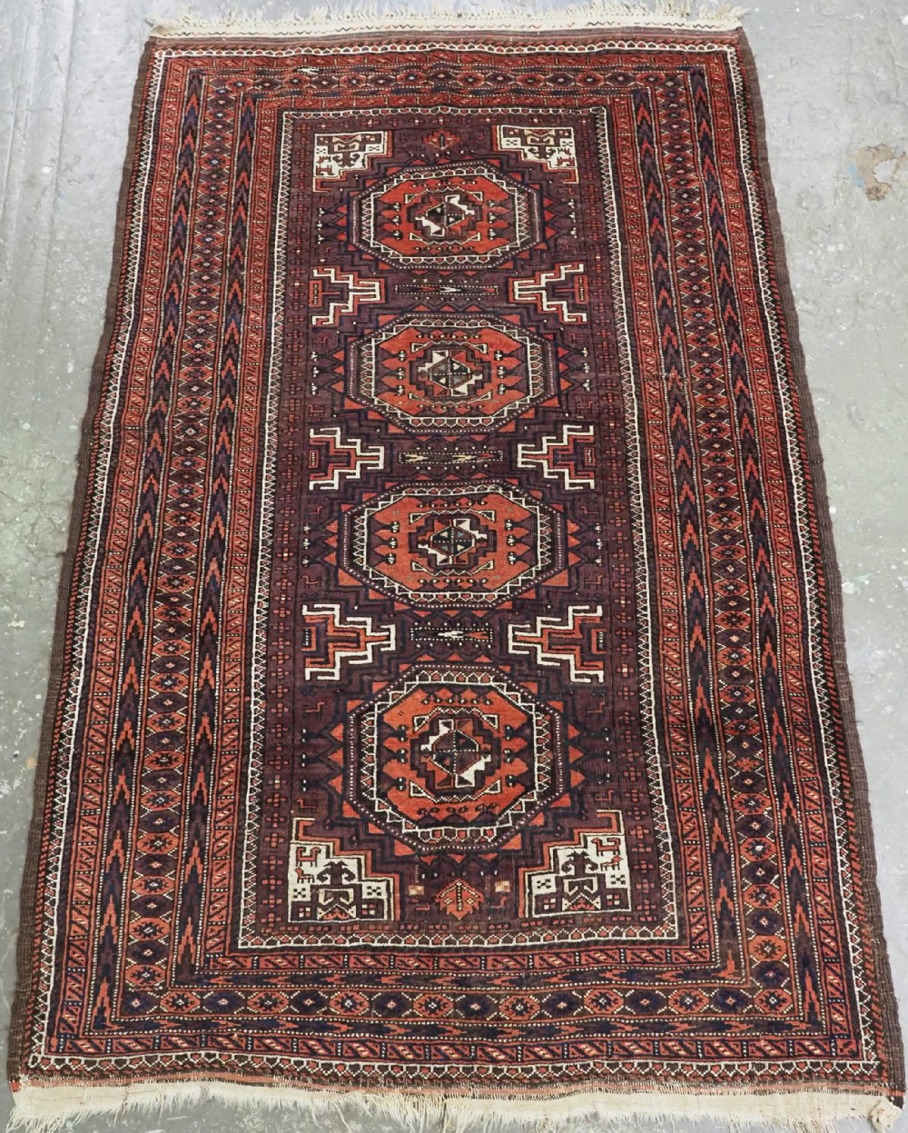 antique yaqoub khani baluch rug octogen design on aubergine ground circa 1900
