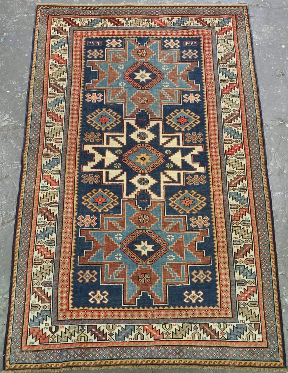 antique caucasian lesghi star design rug dated 1328 1910