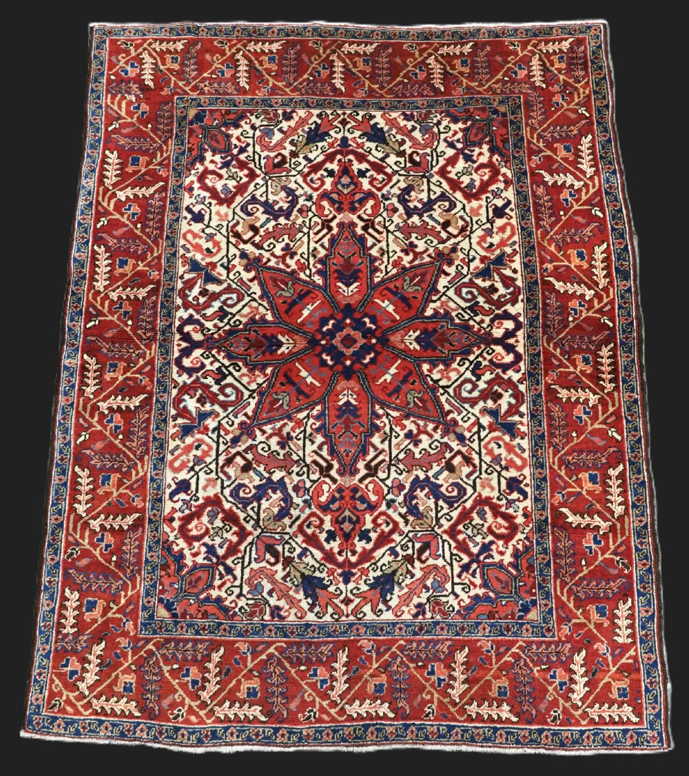 antique heriz rug of small size star medallion on an ivory ground circa 1920