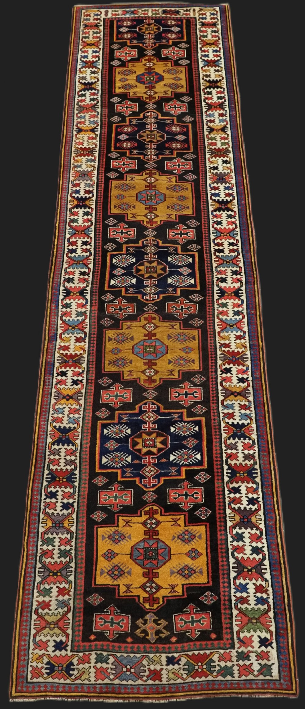 antique caucasian runner of fine weve with repeat medallion design circa 1900