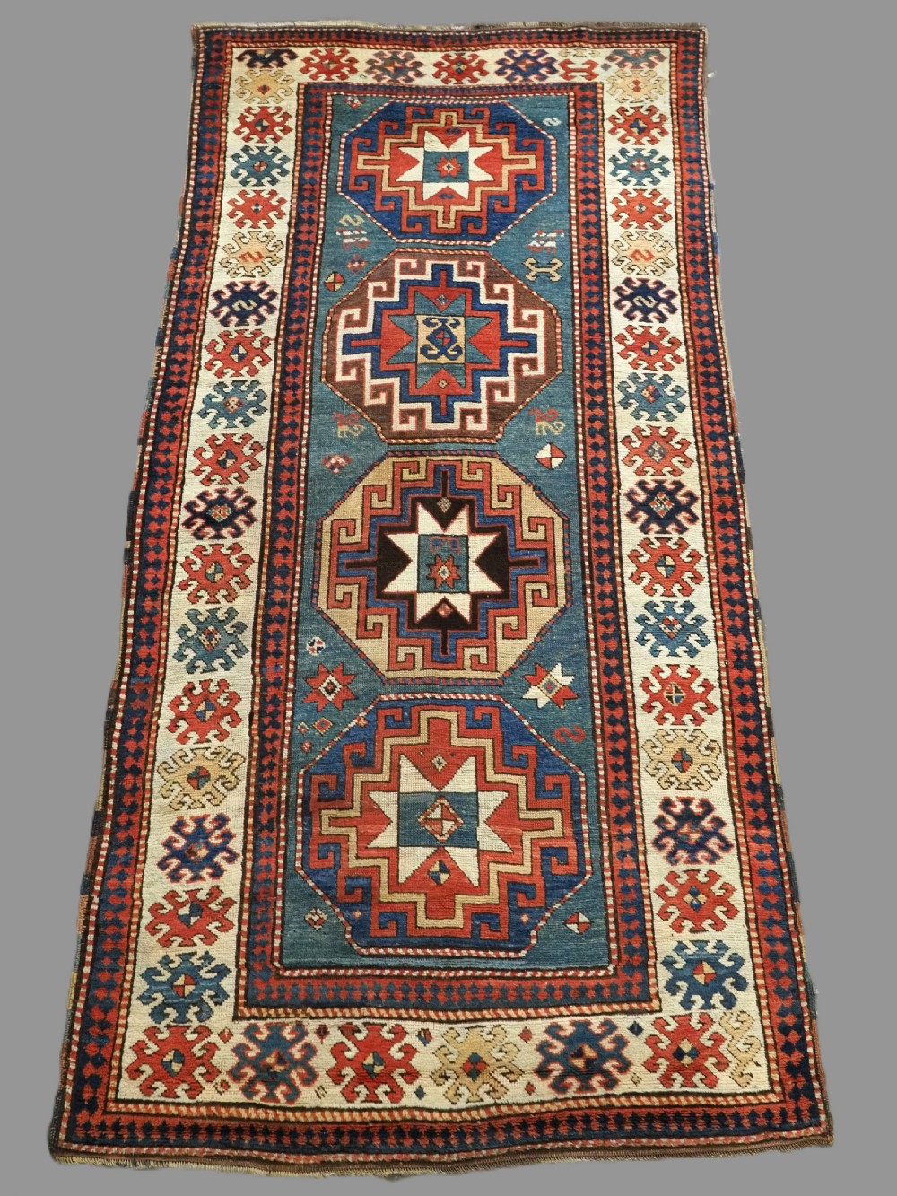 antique caucasian kazak long rug with green ground superb colour 2nd half 19th century